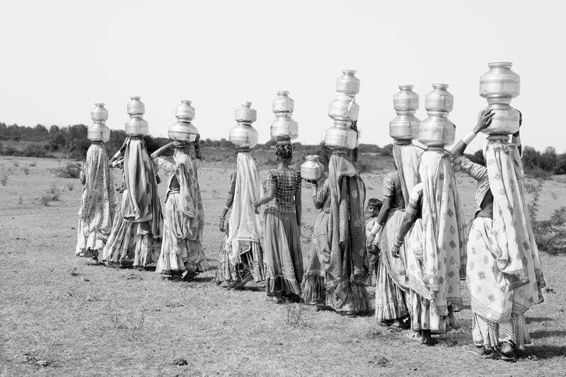 Water portraits - group of women fetching water from a distant source in rural Kutch district, Gujarat